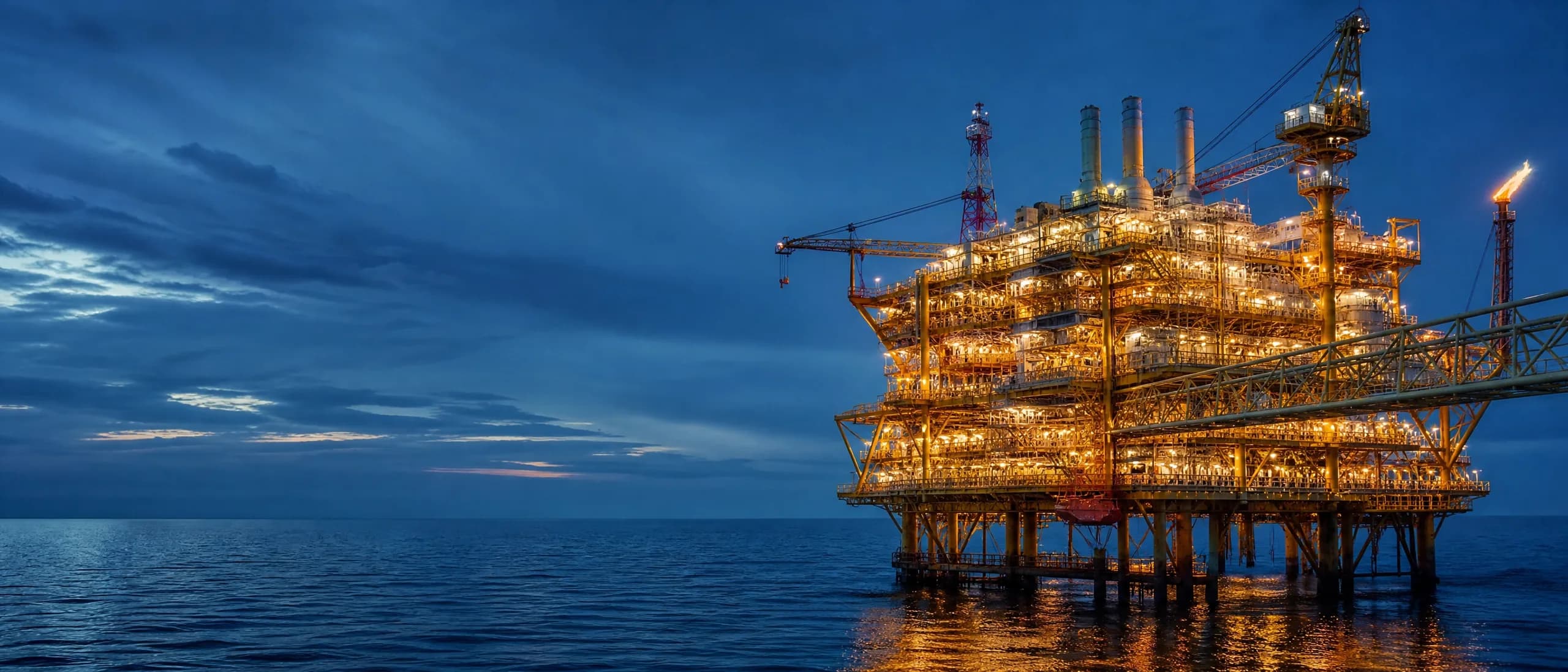 Illuminated offshore oil platform at night